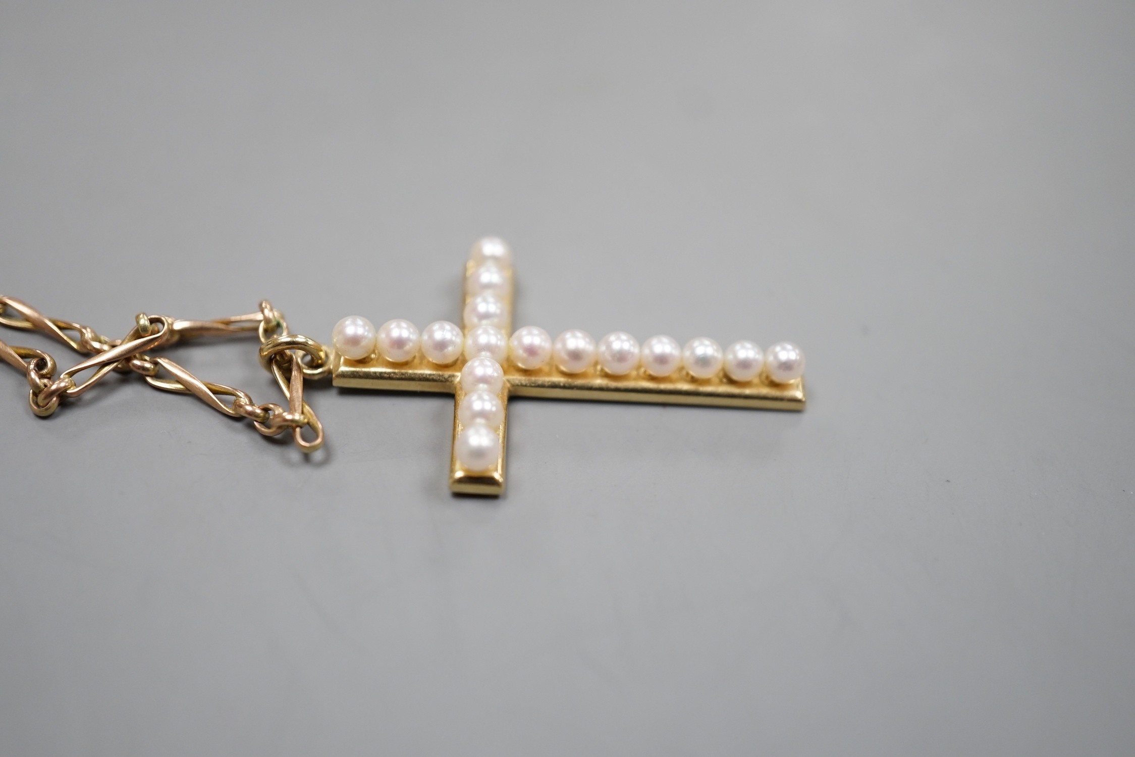A Mikimoto 14k yellow metal and cultured pearl cluster set cross pendant, 35mm, on an associated yellow metal chain, gross weight 8.7 grams.